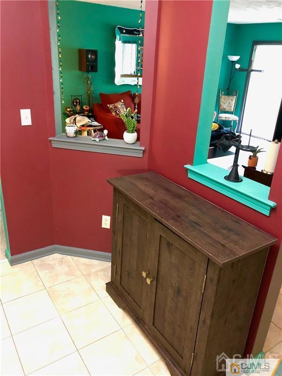 910 Meadow Court, Unit 910 Helmetta, NJ 08828 - Photo 12 of 43 a bathroom with a sink mirror and vanity