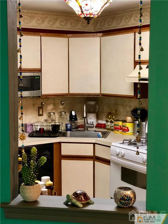 910 Meadow Court, Unit 910 Helmetta, NJ 08828 - Photo 17 of 43 a kitchen with a window a sink and cabinets