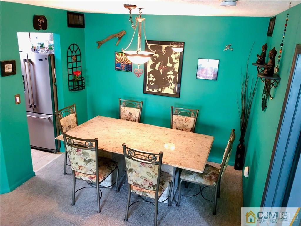 910 Meadow Court, Unit 910 Helmetta, NJ 08828 - Photo 20 of 43 a view of a chairs and table in a livingroom