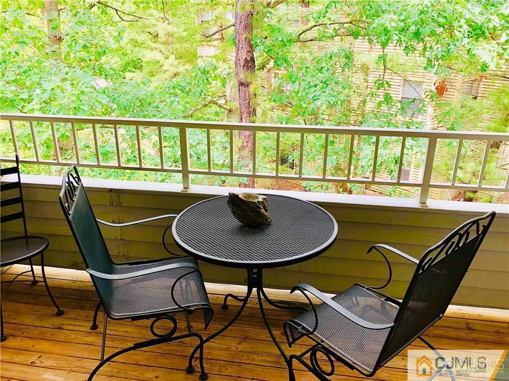 910 Meadow Court, Unit 910 Helmetta, NJ 08828 - Photo 2 of 43 a view of a chairs and table in patio
