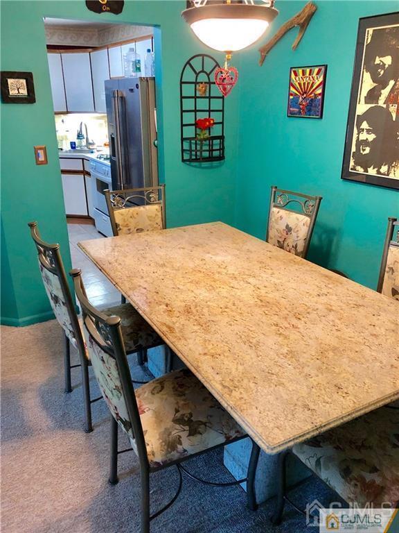 910 Meadow Court, Unit 910 Helmetta, NJ 08828 - Photo 21 of 43 a dining room with furniture and window