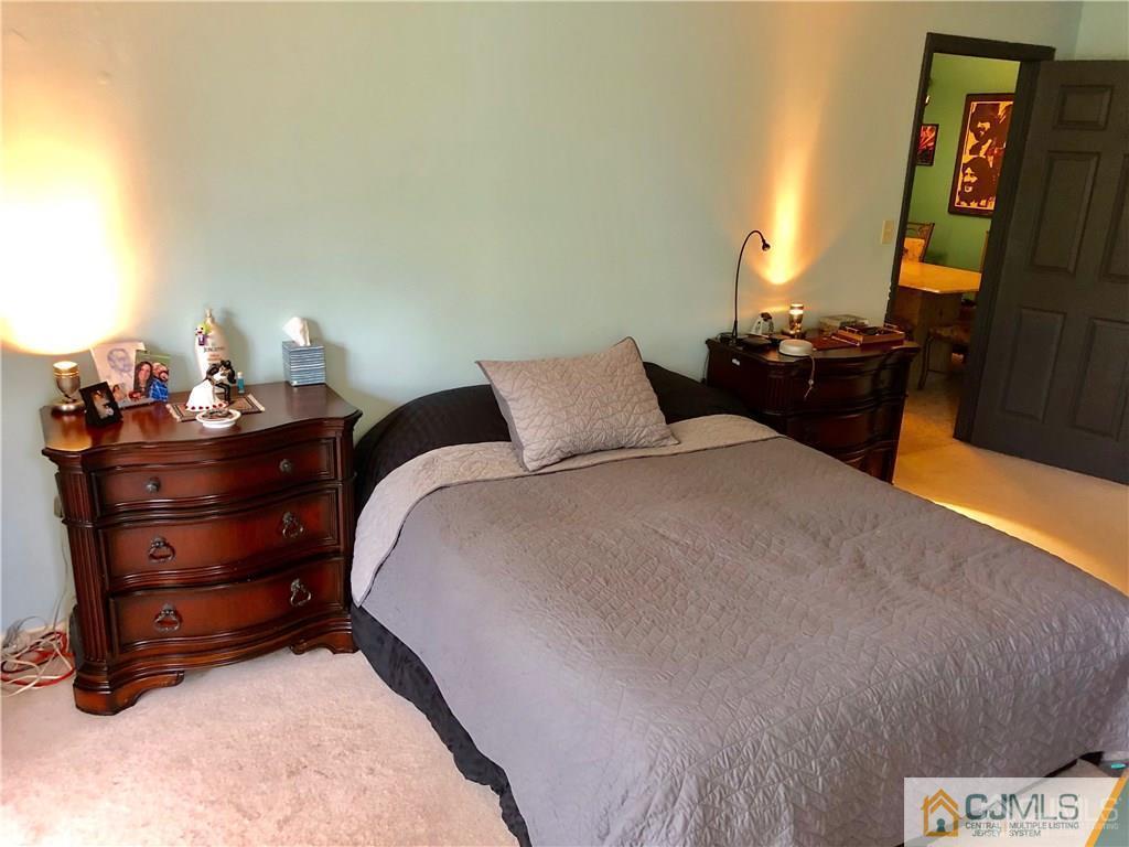 910 Meadow Court, Unit 910 Helmetta, NJ 08828 - Photo 26 of 43 a bed sitting in a bedroom and dresser
