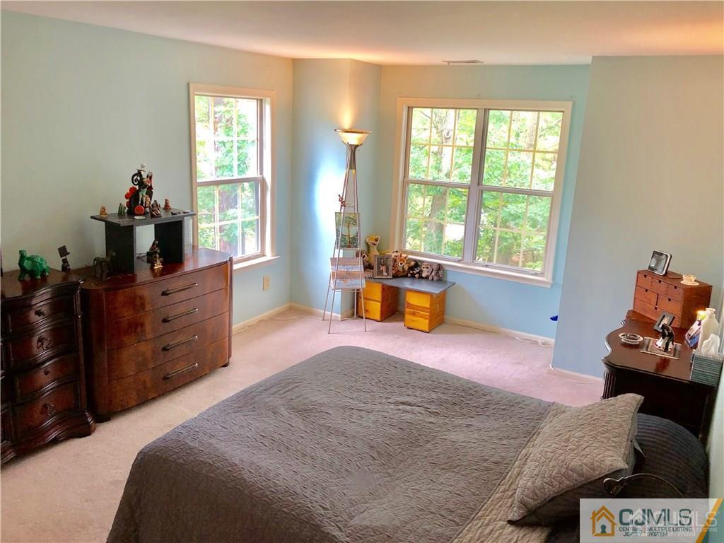 910 Meadow Court, Unit 910 Helmetta, NJ 08828 - Photo 28 of 43 a bedroom with a bed and wooden floor