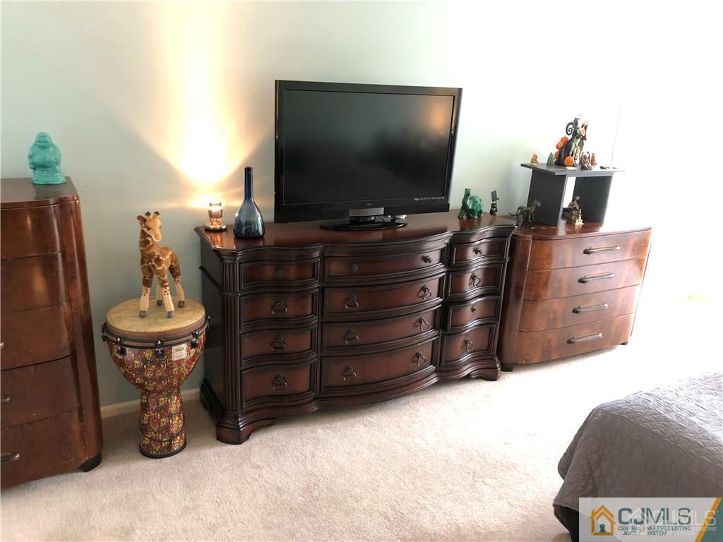 910 Meadow Court, Unit 910 Helmetta, NJ 08828 - Photo 29 of 43 a room with a television and furniture