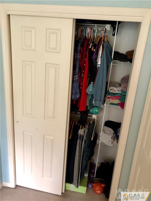 910 Meadow Court, Unit 910 Helmetta, NJ 08828 - Photo 30 of 43 a view of walk in closet with clothes and shoes