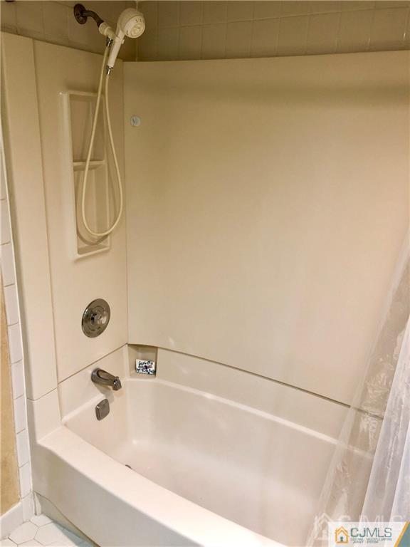 910 Meadow Court, Unit 910 Helmetta, NJ 08828 - Photo 31 of 43 a bathroom with a bath tub and a shower