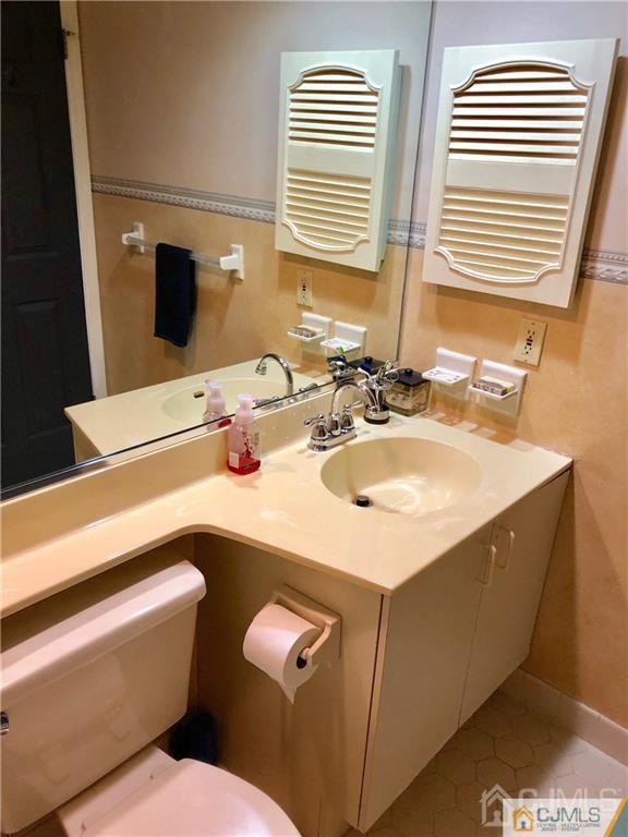 910 Meadow Court, Unit 910 Helmetta, NJ 08828 - Photo 32 of 43 a bathroom with a sink and a toilet