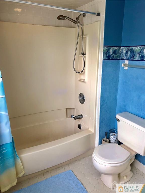 910 Meadow Court, Unit 910 Helmetta, NJ 08828 - Photo 35 of 43 a bathroom with a toilet and a bath tub