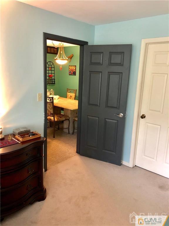 910 Meadow Court, Unit 910 Helmetta, NJ 08828 - Photo 38 of 43 a bedroom with a bed and a window