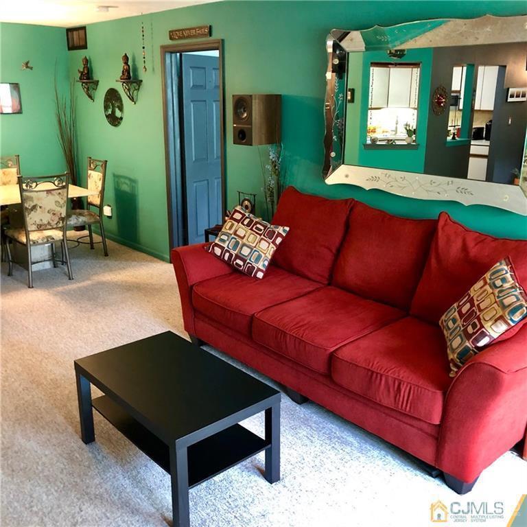 910 Meadow Court, Unit 910 Helmetta, NJ 08828 - Photo 9 of 43 a living room with furniture and a potted plant
