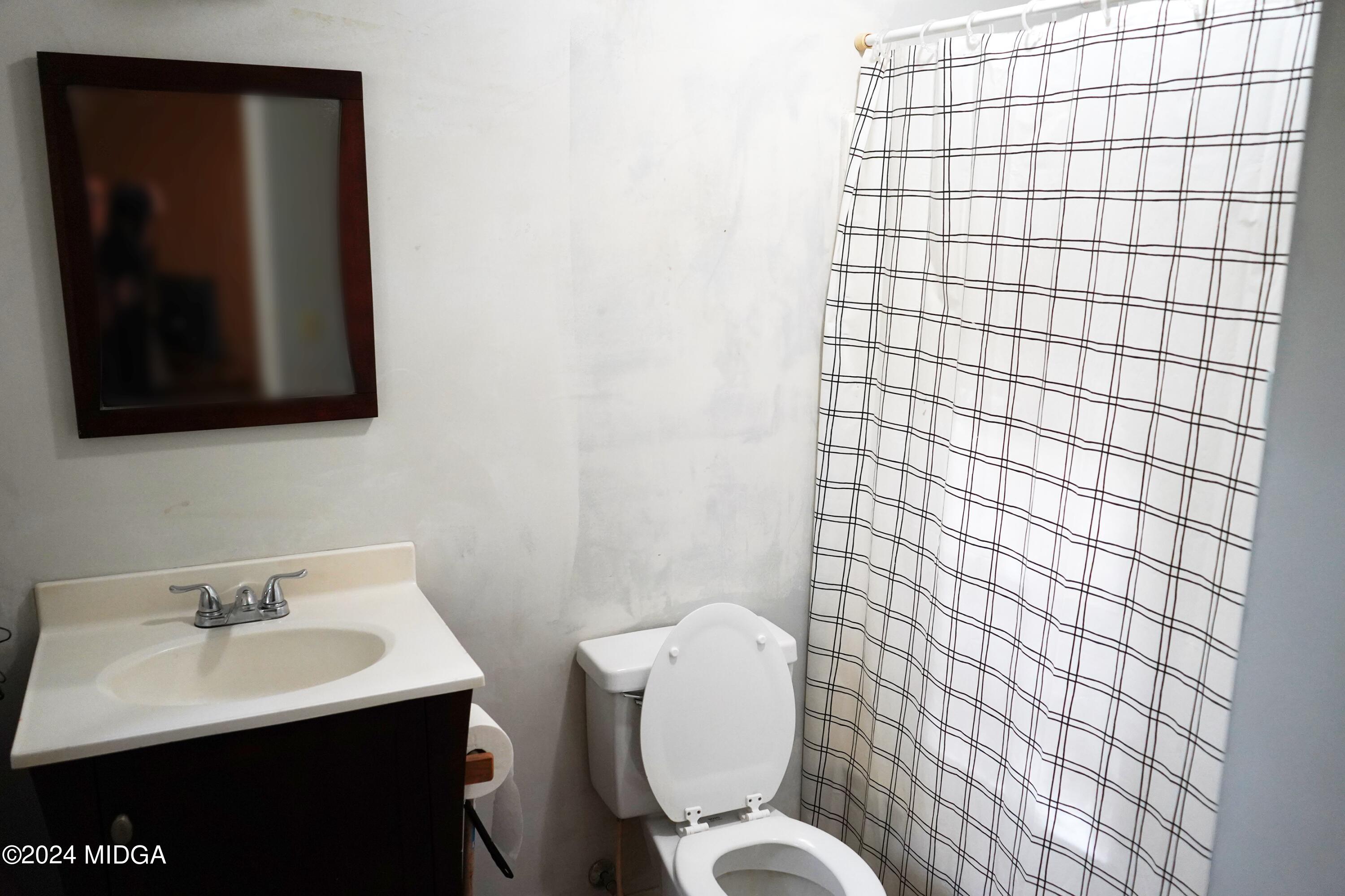 1082 Old Cabaniss Road Forsyth, GA 31029 - Photo 11 of 14 a bathroom with a sink toilet and mirror