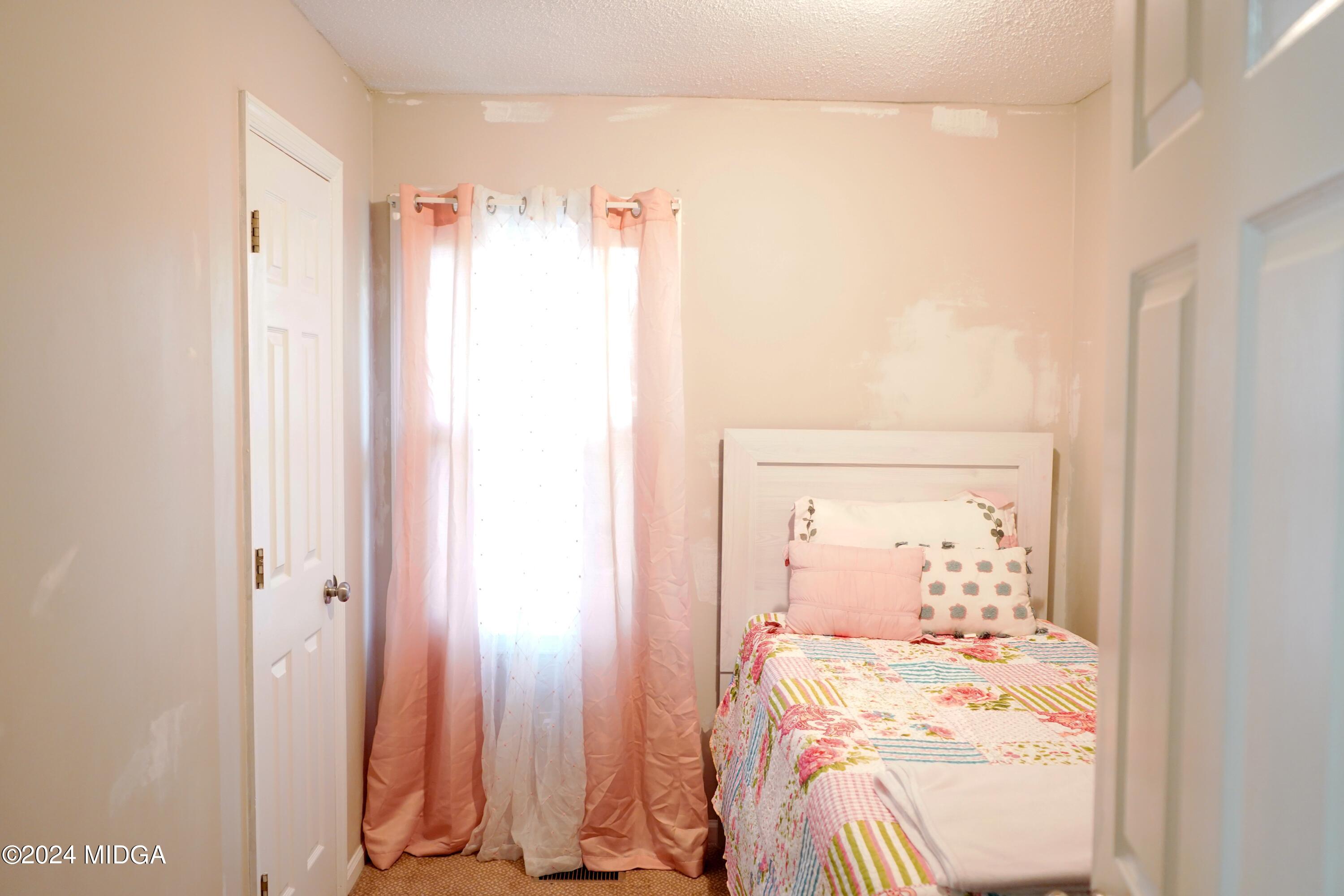 1082 Old Cabaniss Road Forsyth, GA 31029 - Photo 12 of 14 a room with a bed and a mirror