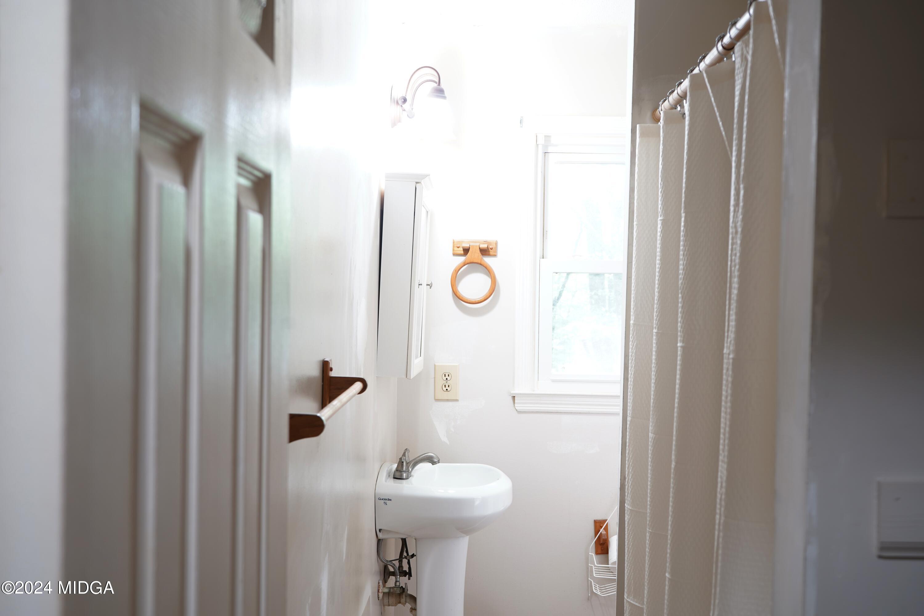 1082 Old Cabaniss Road Forsyth, GA 31029 - Photo 13 of 14 a bathroom with a sink toilet and shower