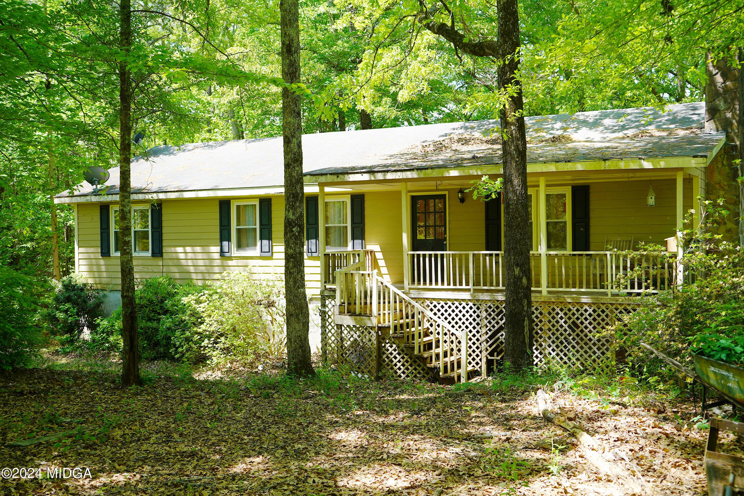1082 Old Cabaniss Road Forsyth, GA 31029 - Photo 2 of 14 a view of a house with a large window and yard