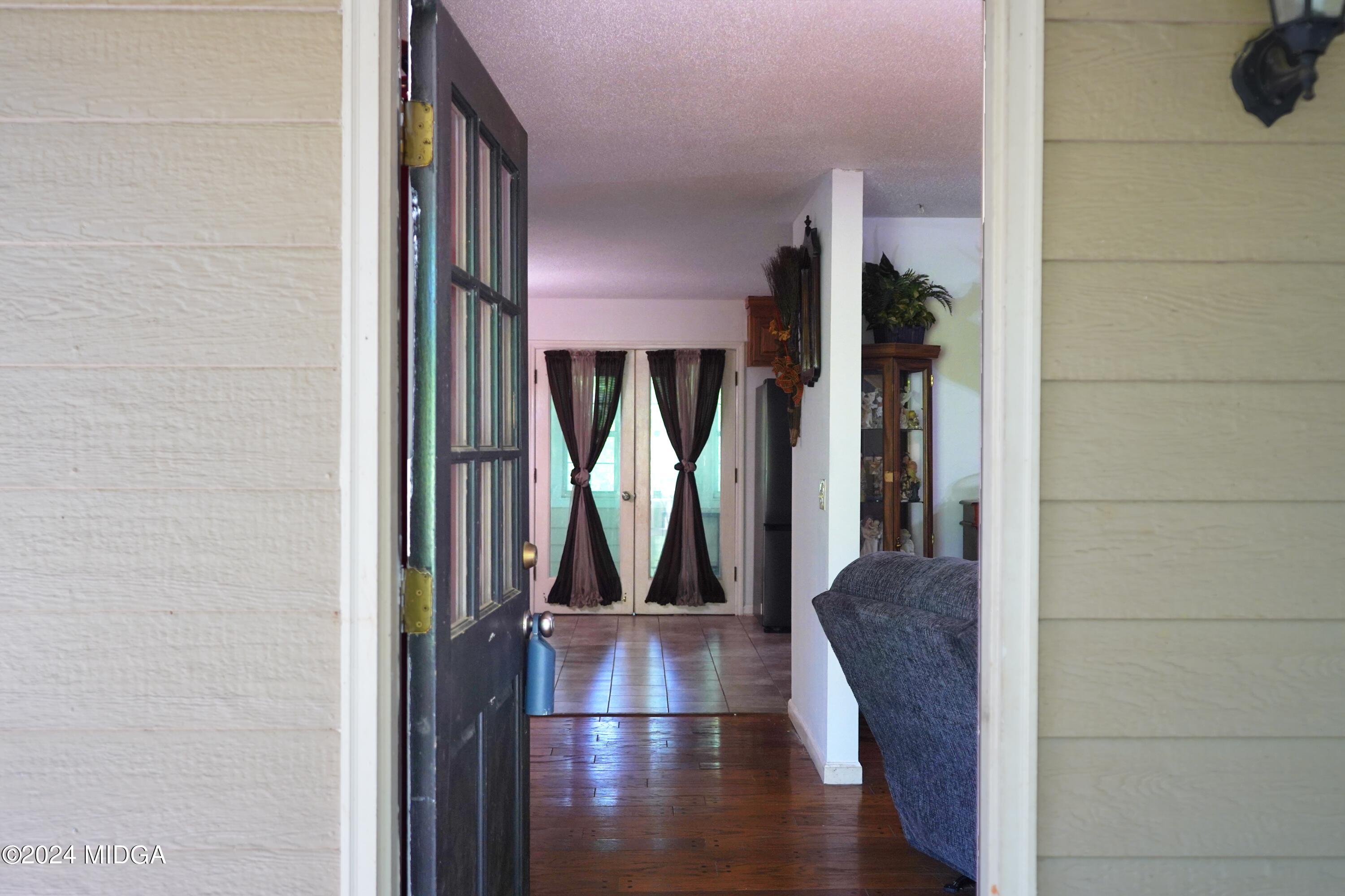 1082 Old Cabaniss Road Forsyth, GA 31029 - Photo 3 of 14 a view of a living room with entryway and wooden floor