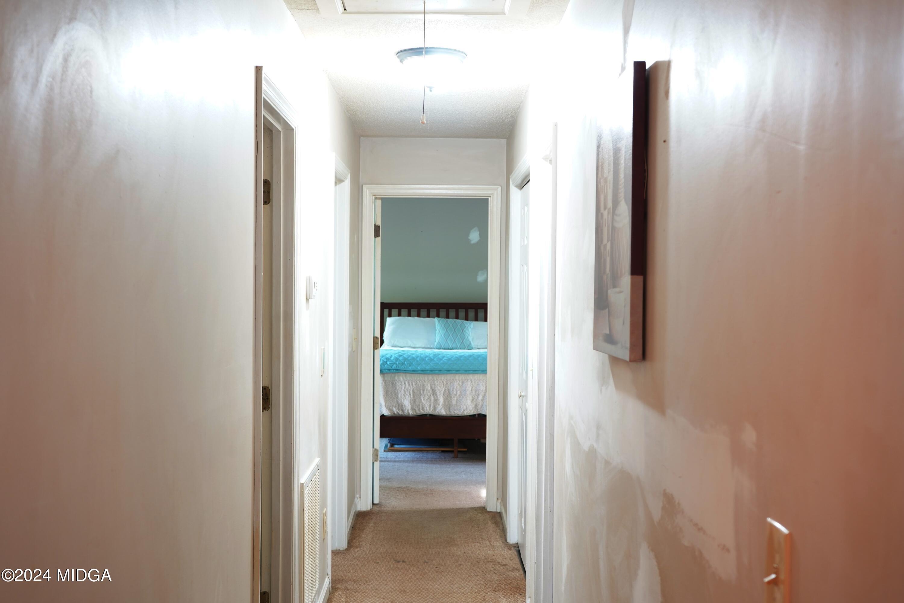 1082 Old Cabaniss Road Forsyth, GA 31029 - Photo 8 of 14 a view of a hallway with wooden floor