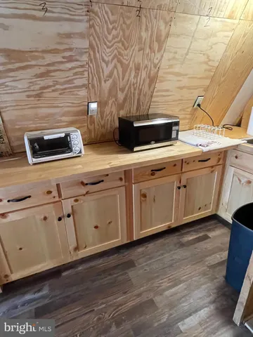 a kitchen with stainless steel appliances a stove a sink and white cabinets