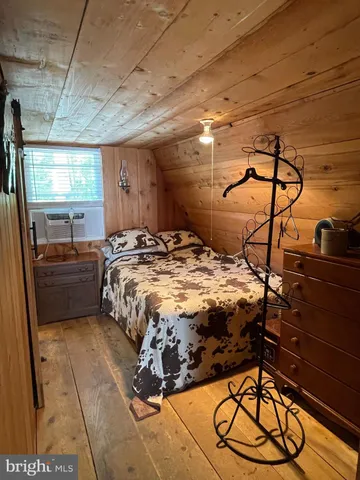 a bedroom with a bed and a mirror