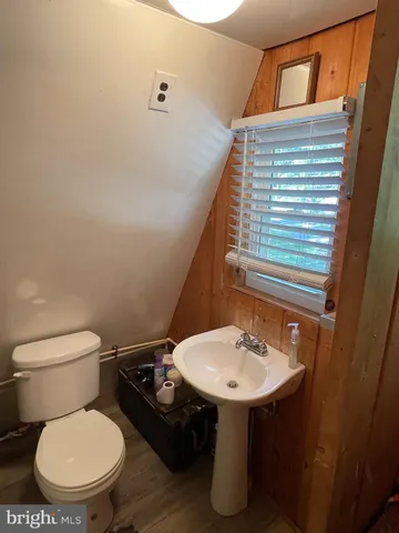 a bathroom with a sink a toilet and mirror