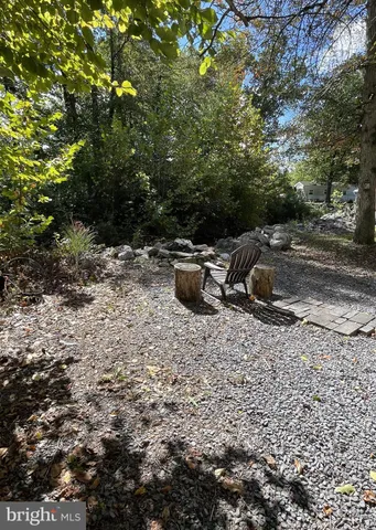 a view of a backyard with table and chairs