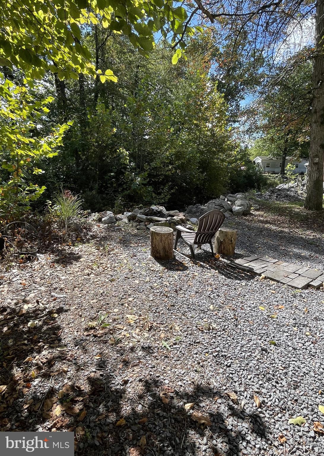 198 Black Gap Road, Unit 56 Fayetteville, PA 17222 - Photo 27 of 30 a view of a backyard with table and chairs