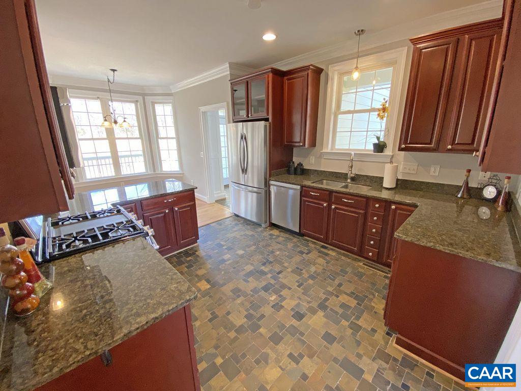 1050 Garth Road Stanardsville, VA 22973 - Photo 7 of 29 a large kitchen with kitchen island granite countertop a sink stove and refrigerator
