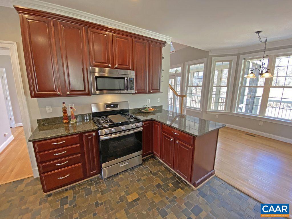 1050 Garth Road Stanardsville, VA 22973 - Photo 8 of 29 a kitchen with stainless steel appliances granite countertop a stove a sink and a microwave