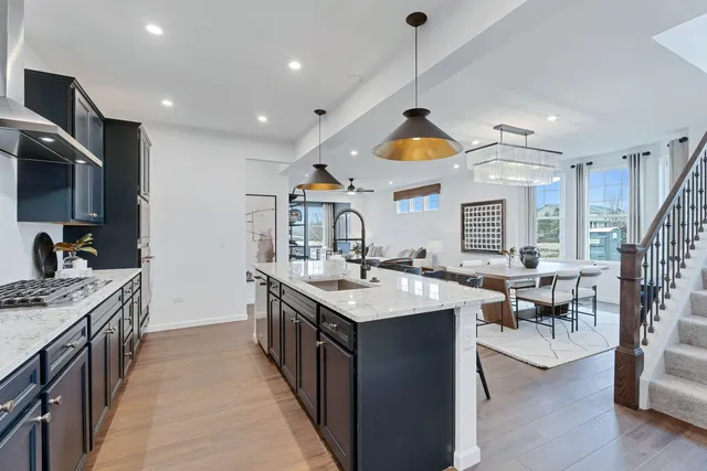 a kitchen with stainless steel appliances granite countertop a sink and a stove