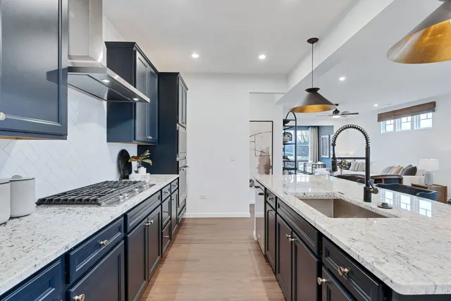 a kitchen with granite countertop a sink and stove