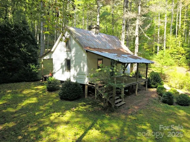 a backyard of a house with yard and outdoor seating