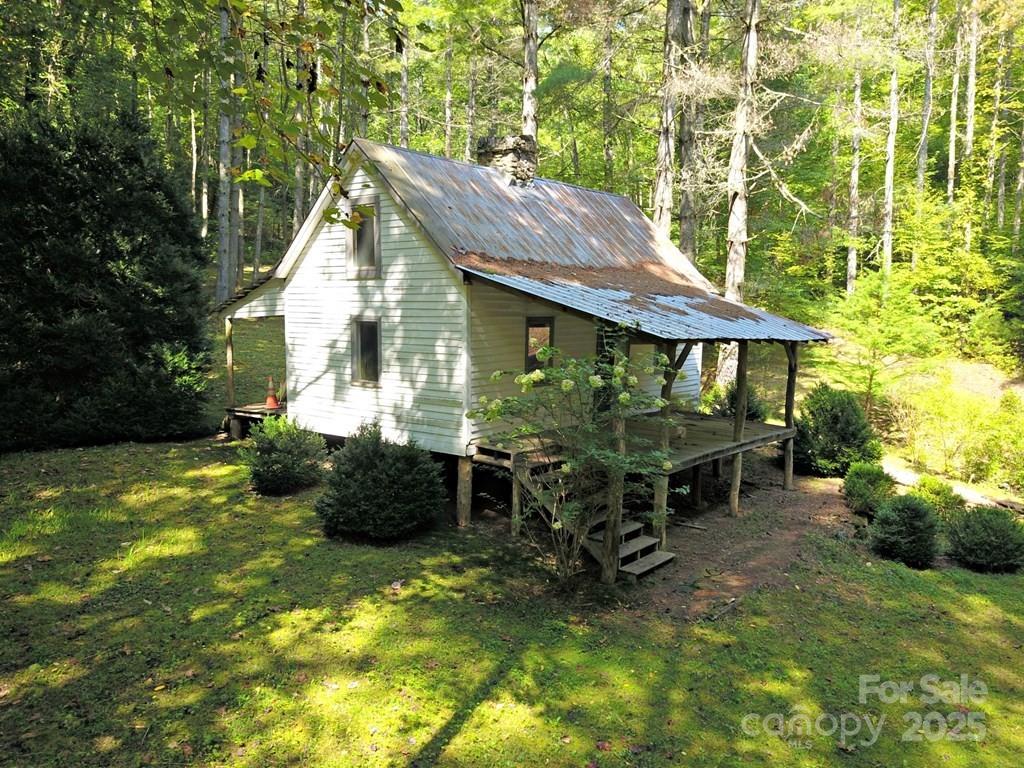 0 Mountain Forest Estate Road Sylva, NC 28779 - Photo 5 of 16 a backyard of a house with yard and outdoor seating