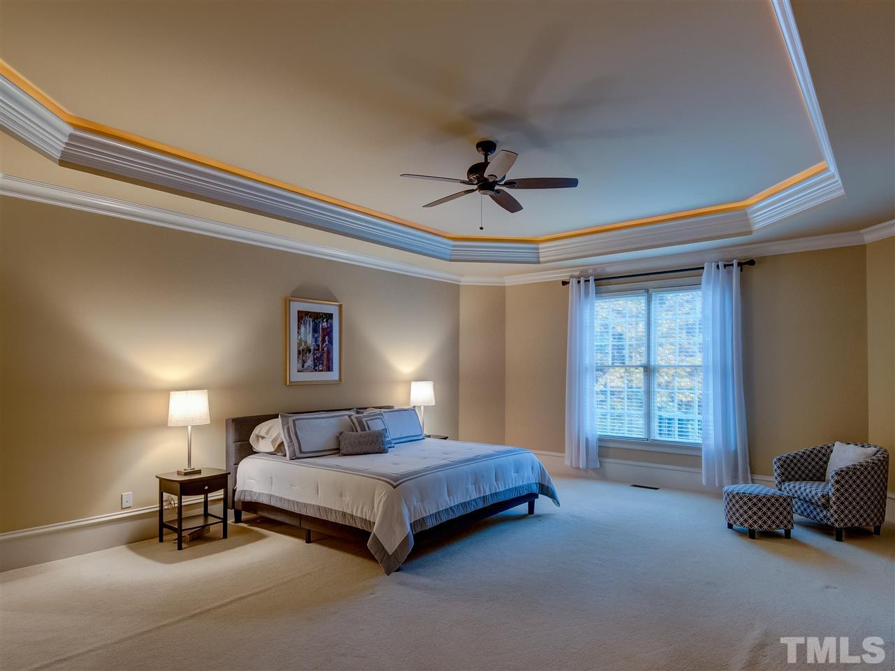 1908 Ridge Road Raleigh, NC 27607 - Photo 13 of 30 a spacious bedroom with a bed and a chandelier