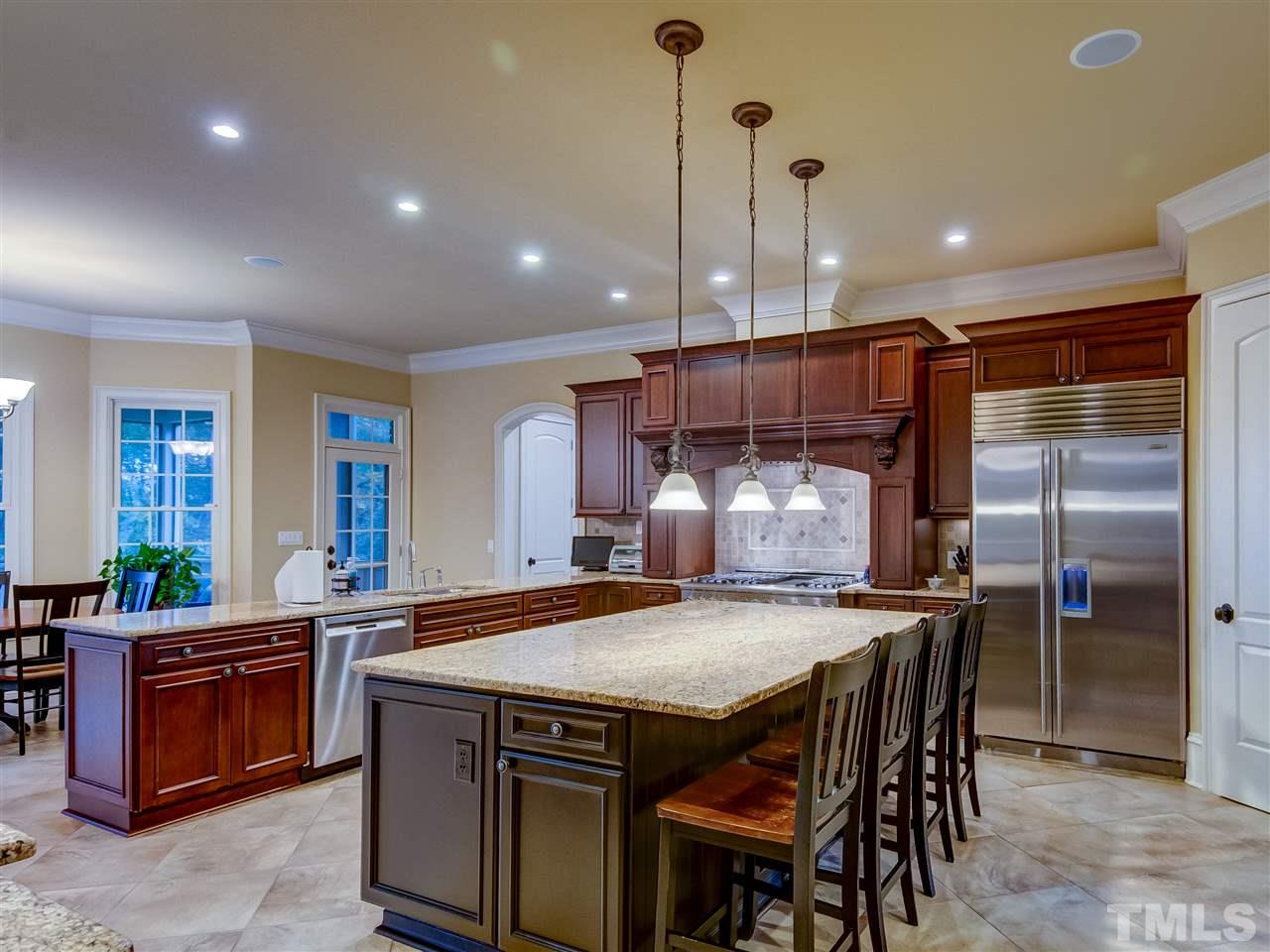 1908 Ridge Road Raleigh, NC 27607 - Photo 7 of 30 a kitchen with stainless steel appliances granite countertop a kitchen island a stove and a refrigerator