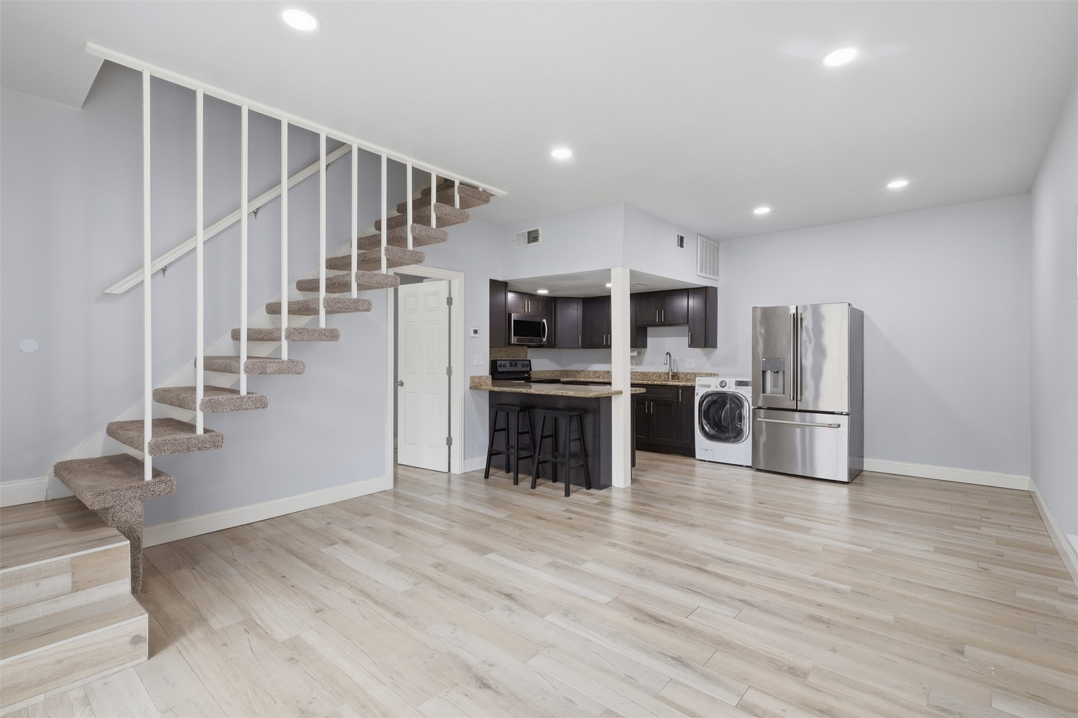 811 Threadneedle Street, Unit 287 Houston, TX 77079 - Photo 3 of 16 Bright and spacious living area with open staircase and modern finishes.