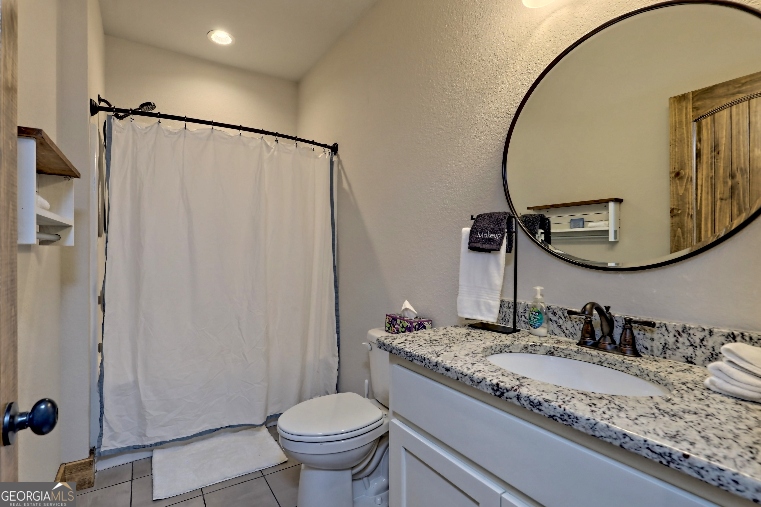 4979 Highway 197 Clarkesville, GA 30523 - Photo 19 of 62 a bathroom with a granite countertop sink toilet mirror and a shower