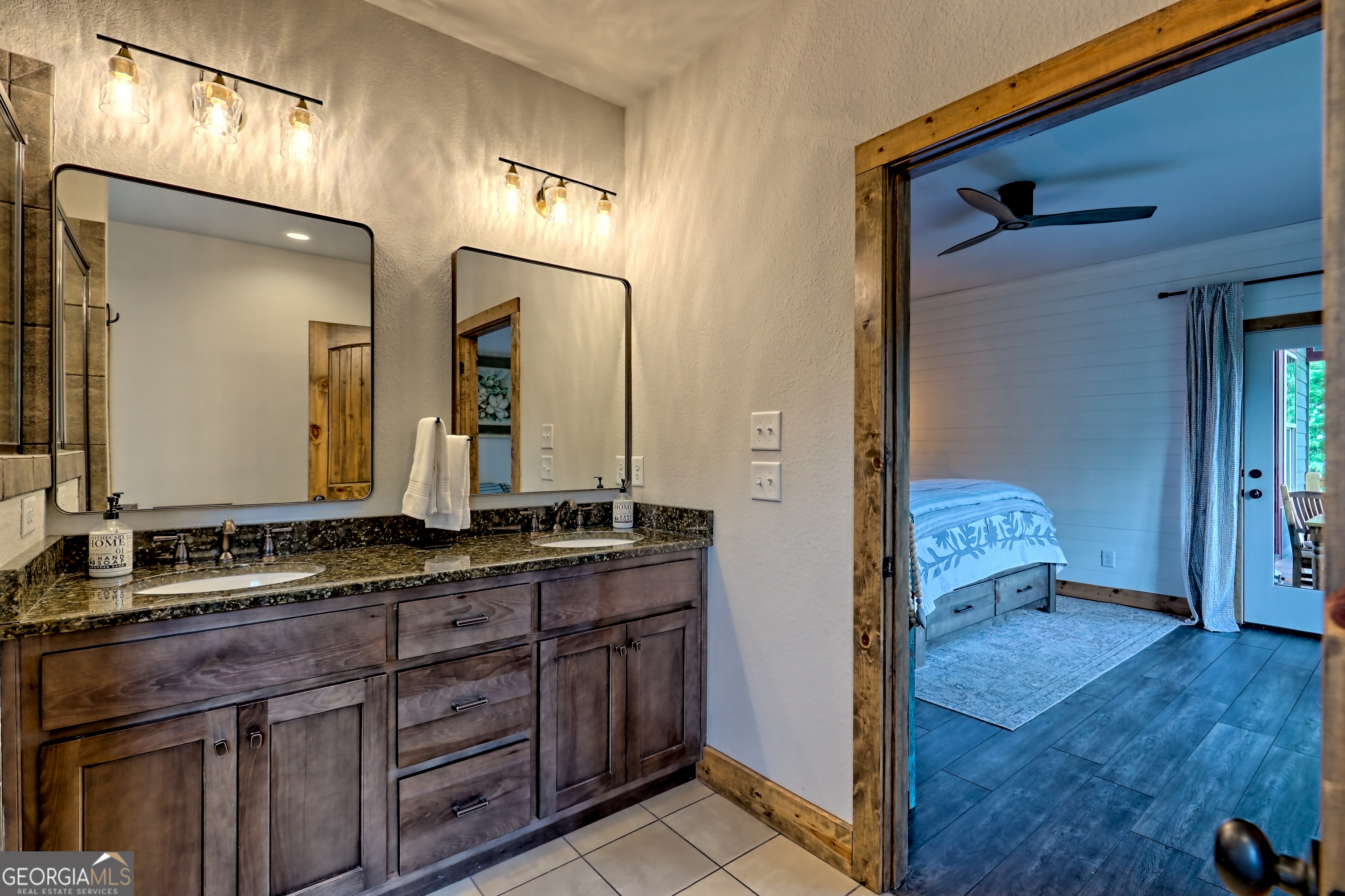 4979 Highway 197 Clarkesville, GA 30523 - Photo 27 of 62 a en suite bathroom with a granite countertop sink and a mirror