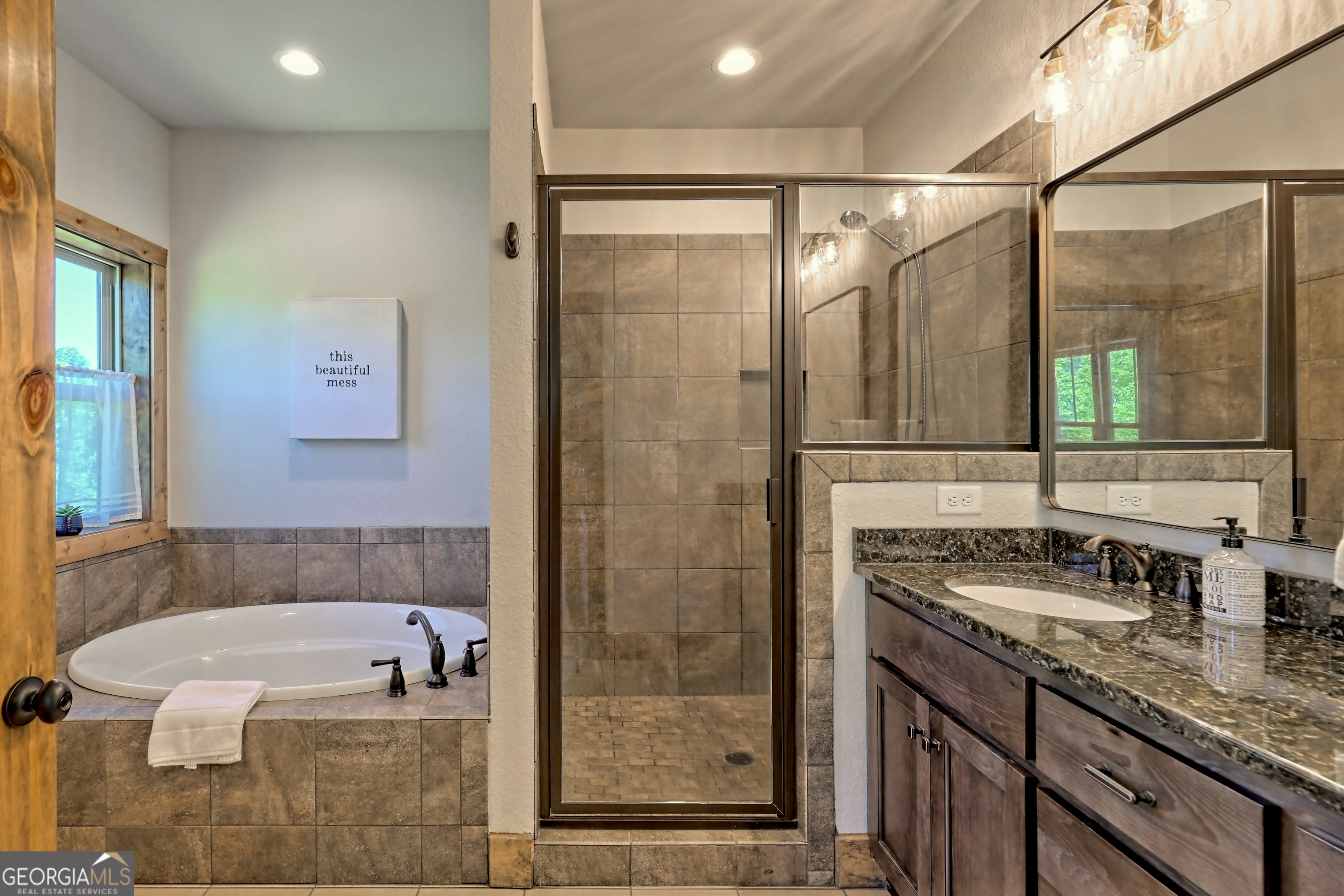 4979 Highway 197 Clarkesville, GA 30523 - Photo 28 of 62 a bathroom with a granite countertop sink a mirror and shower