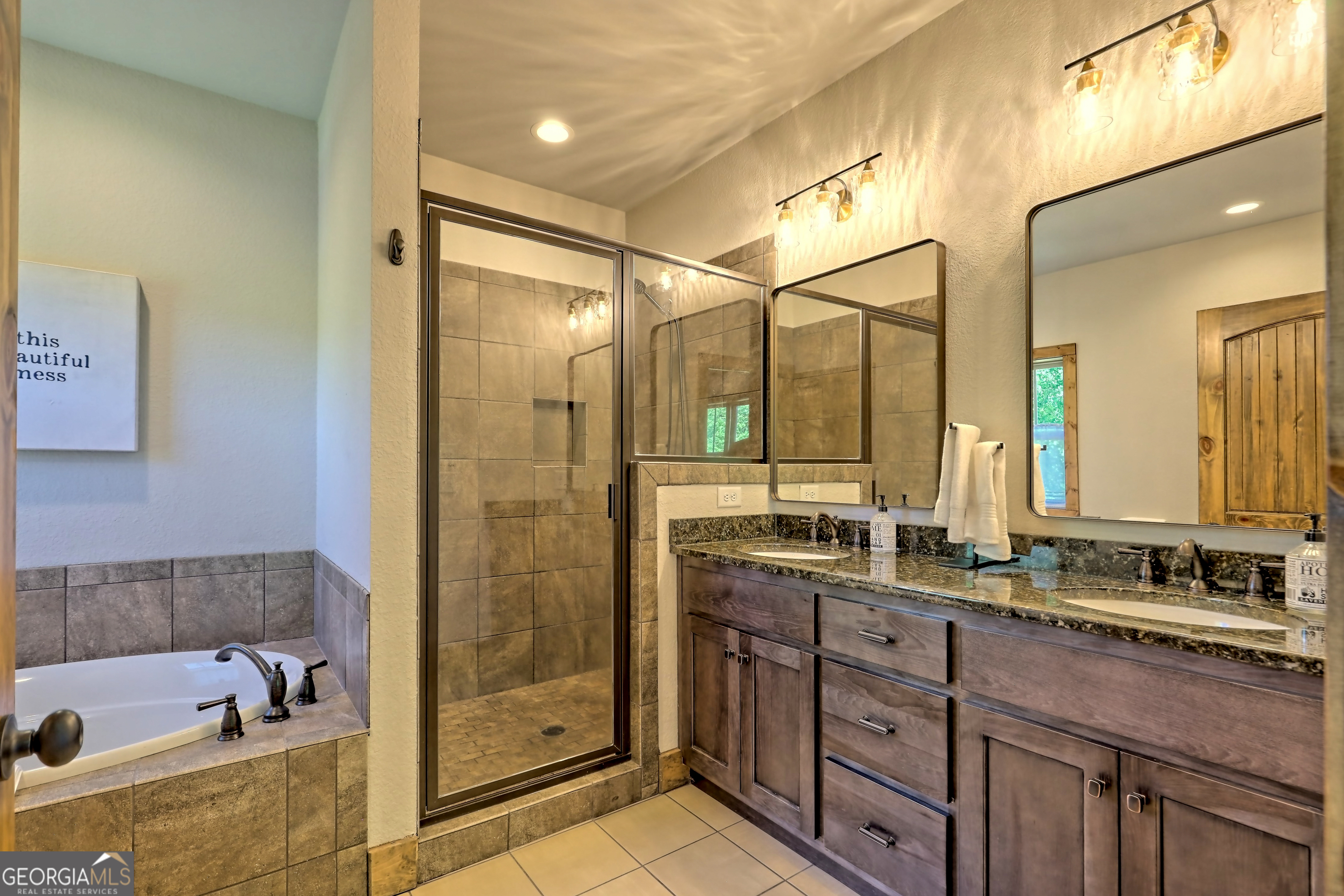 4979 Highway 197 Clarkesville, GA 30523 - Photo 29 of 62 a bathroom with a tub sink shower and mirror