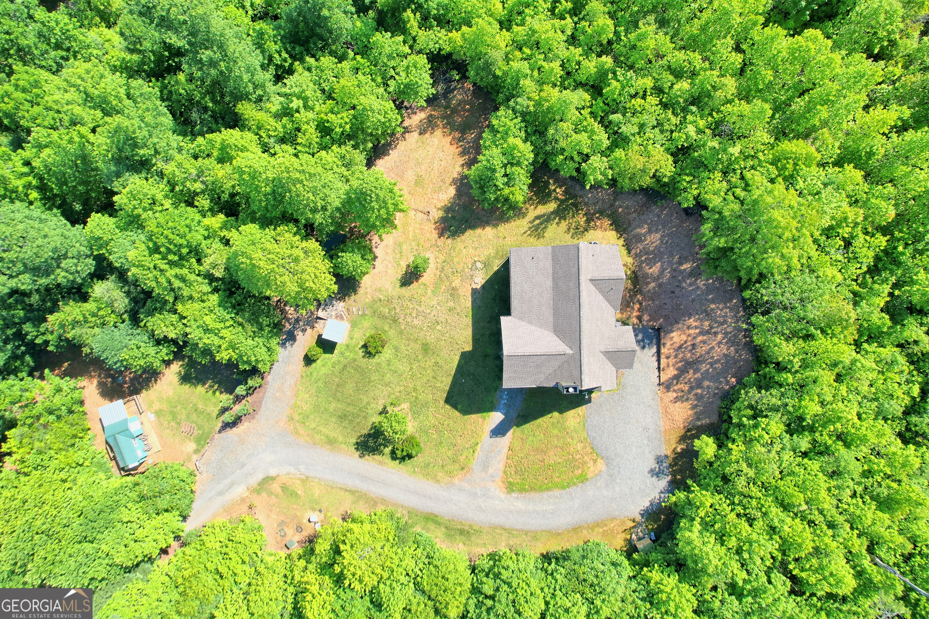 4979 Highway 197 Clarkesville, GA 30523 - Photo 52 of 62 an aerial view of a house with a yard and large trees