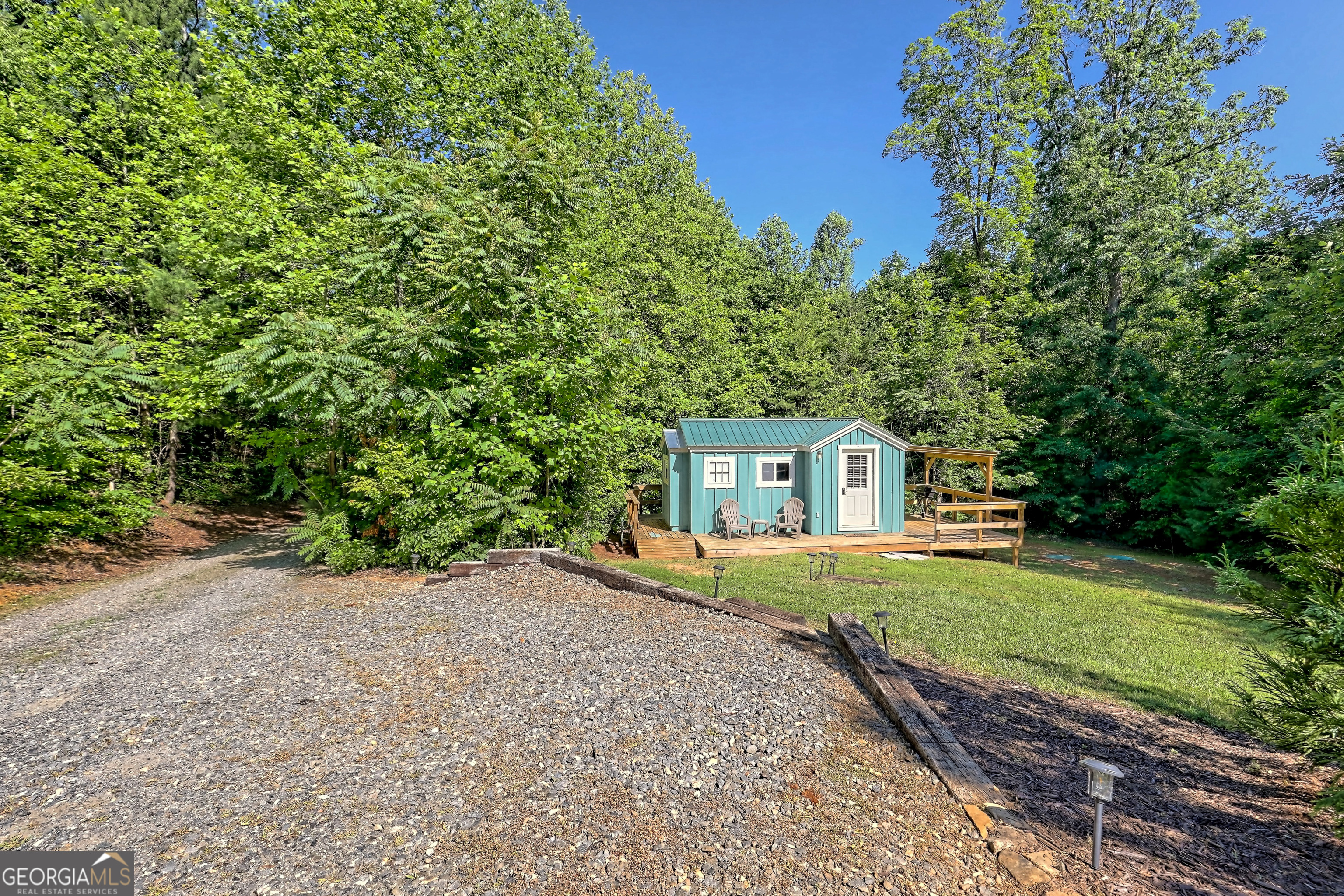 4979 Highway 197 Clarkesville, GA 30523 - Photo 59 of 62 a front view of a house with a yard and garage