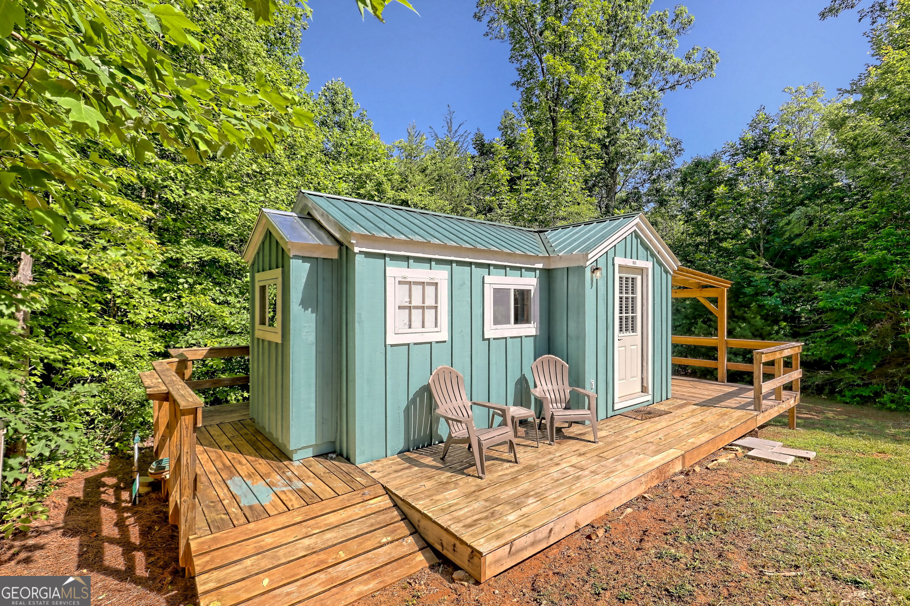 4979 Highway 197 Clarkesville, GA 30523 - Photo 60 of 62 a view of a house with backyard sitting area and garden