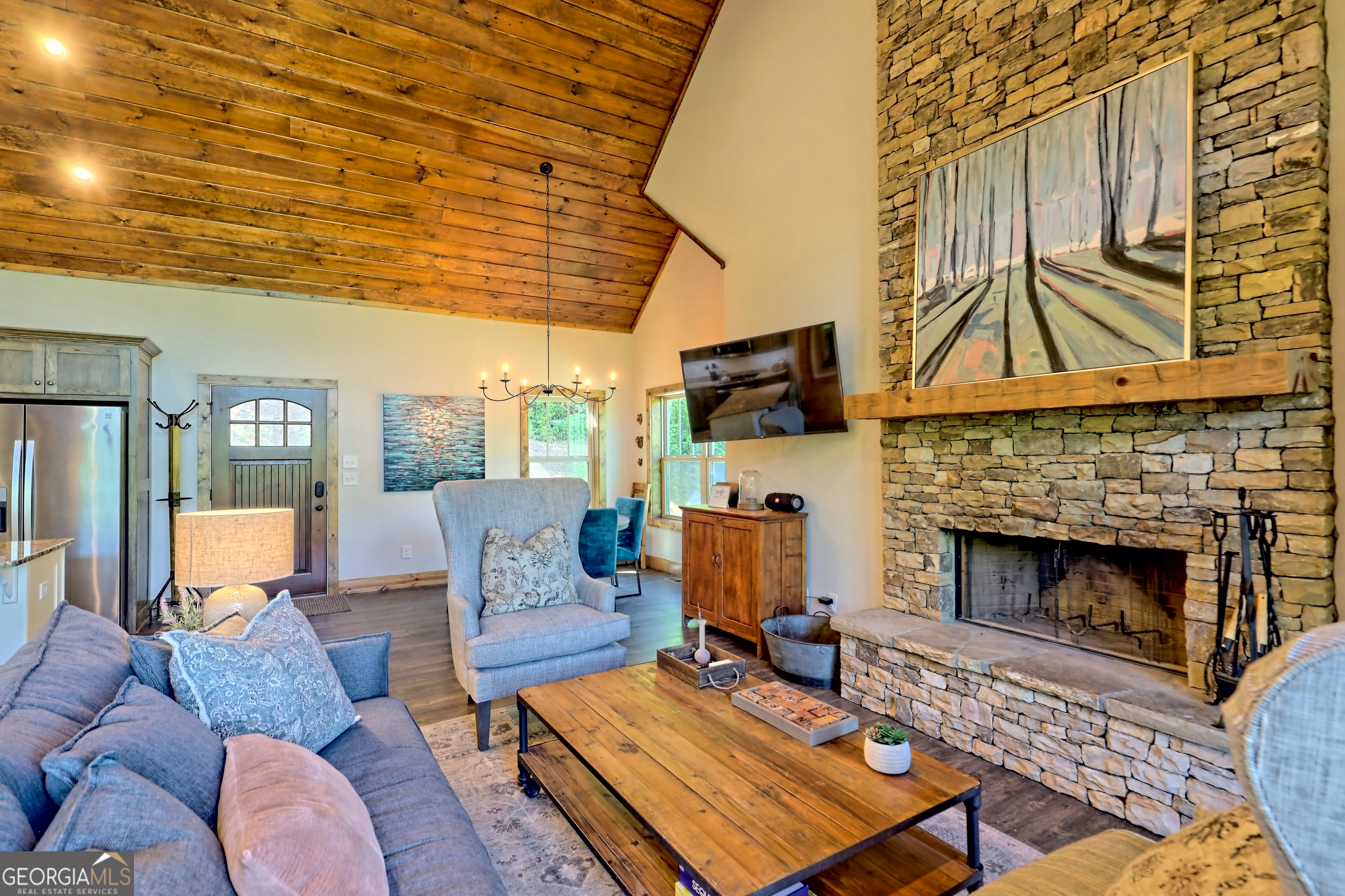 4979 Highway 197 Clarkesville, GA 30523 - Photo 6 of 62 a living room with furniture a flat screen tv and a fireplace