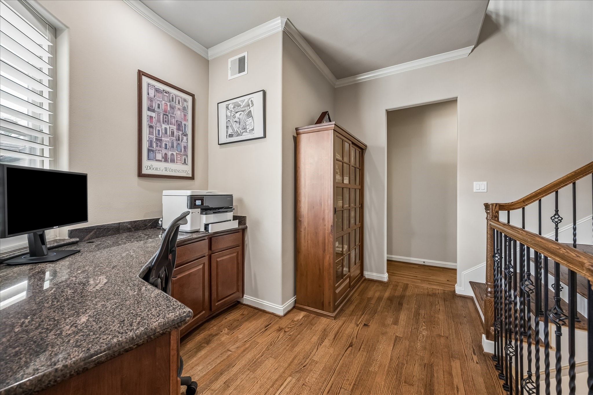 907 Queen Annes Road Houston, TX 77024 - Photo 20 of 31 Versatile upstairs study nook with built-in workspace, ideal for a home office, homework station, or additional flex space.