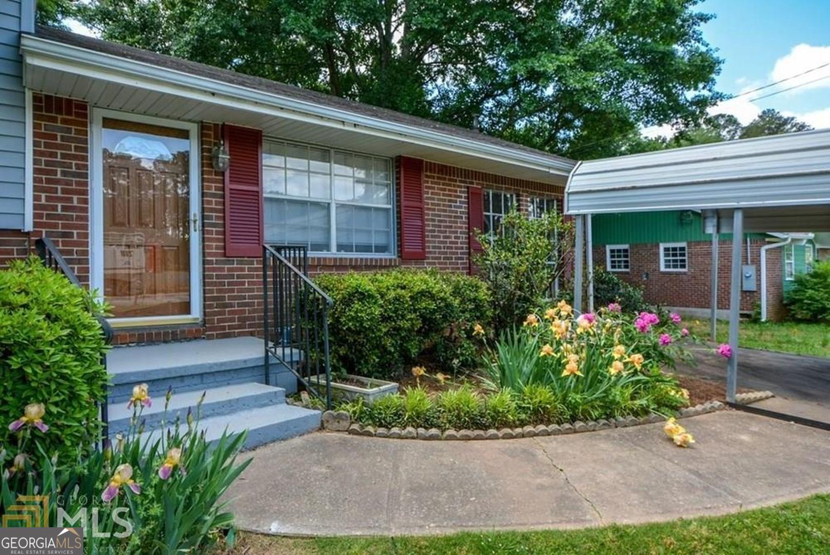 a front view of a house with garden