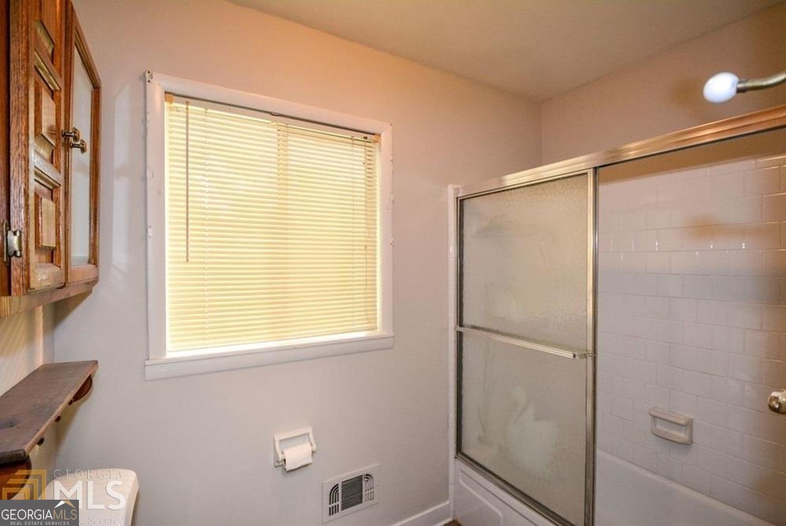 110 Flint River Road Jonesboro, GA 30238 - Photo 11 of 18 a bathroom with a bathtub and a shower