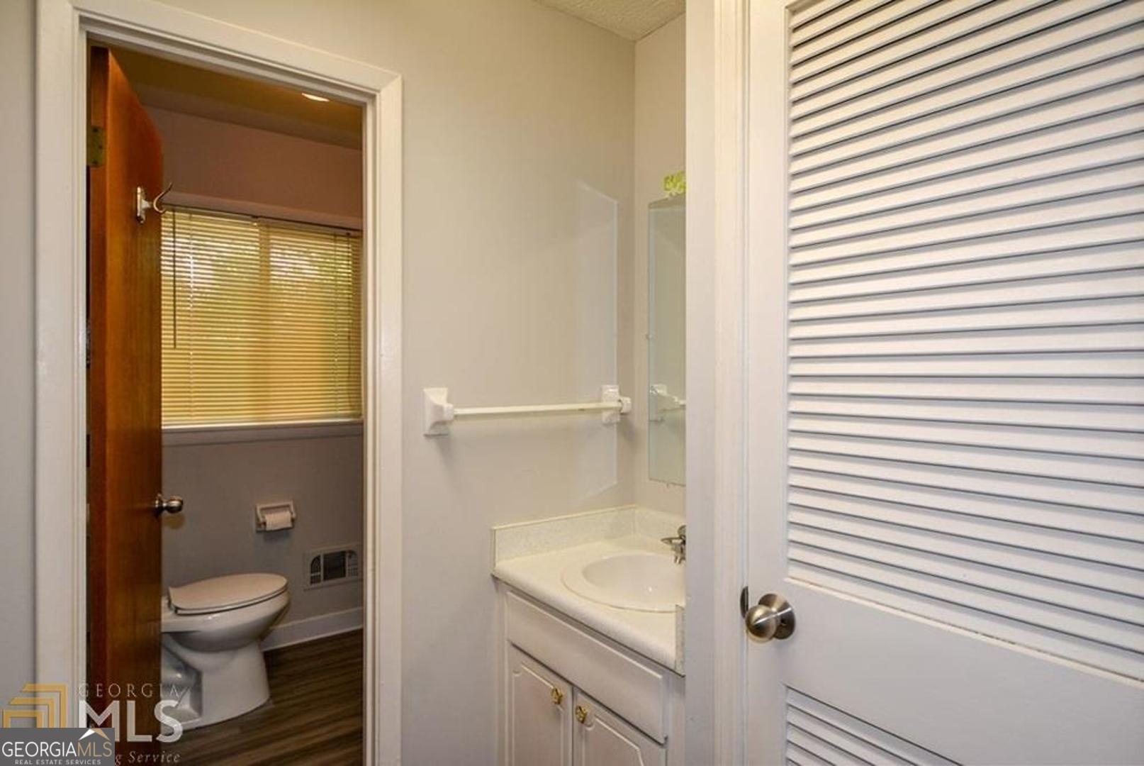 110 Flint River Road Jonesboro, GA 30238 - Photo 12 of 18 a bathroom with a granite countertop toilet and a sink
