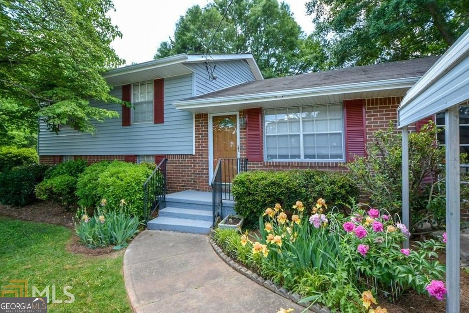 110 Flint River Road Jonesboro, GA 30238 - Photo 18 of 18 a front view of a house with a yard and potted plants