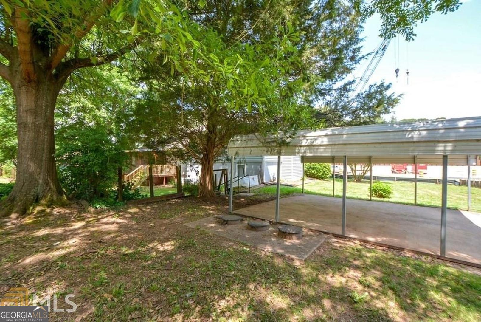 110 Flint River Road Jonesboro, GA 30238 - Photo 2 of 18 a view of a backyard with a large tree