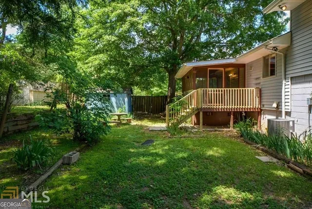 a view of a house with a yard and a garden