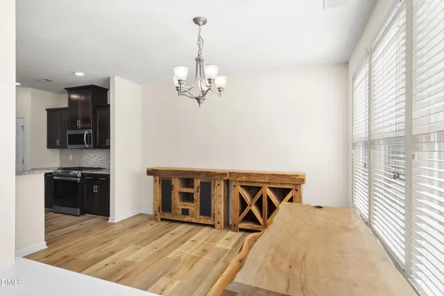 a living room with furniture and kitchen view